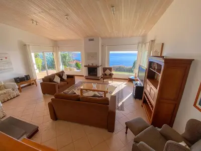 a large living room with a couch and a tv at Villa Albatroz in Caniço