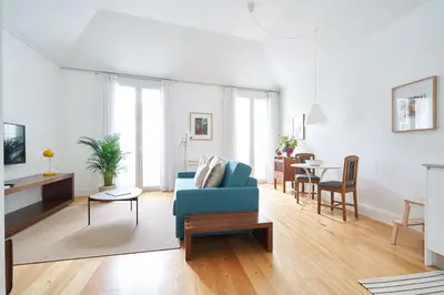 a living room with a blue couch and a table at Good Memories Lodge in Funchal