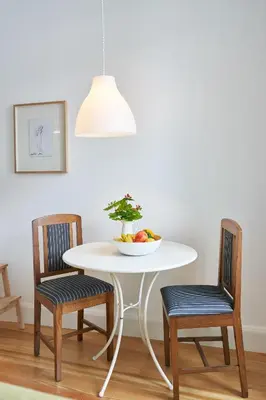 a white table with two chairs and a bowl of fruit at Good Memories Lodge in Funchal