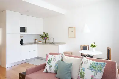 a living room with a couch and a kitchen at Good Memories Lodge in Funchal