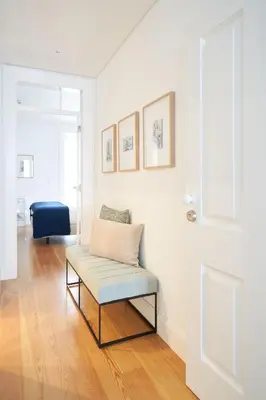 a living room with a bench and a blue chair at Good Memories Lodge in Funchal