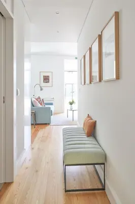 a living room with white walls and a bench at Good Memories Lodge in Funchal