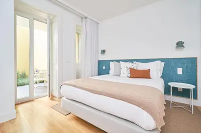 a bedroom with a large bed and a window at Good Memories Lodge in Funchal