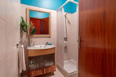 a bathroom with a sink and a shower and a mirror at Barcelos Apartment by Holiday Rental Madeira in Funchal