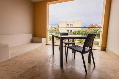 a dining room with a table and chairs and a window at The Navigator - Colombus Apartments & Villas in Porto Santo
