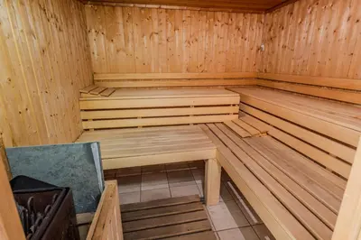 a wooden sauna with a wooden bench in it at The Navigator - Colombus Apartments & Villas in Porto Santo