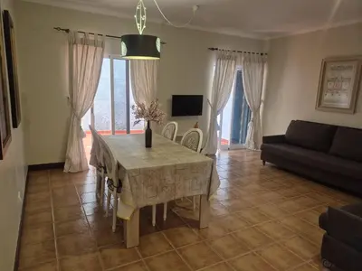 a living room with a table and a couch at Apartamentos Arrifes 1 in Porto Santo