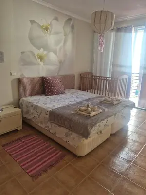 a bedroom with a bed with flowers on the wall at Apartamentos Arrifes 1 in Porto Santo