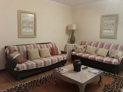 a living room with two couches and a coffee table at Apartamentos Arrifes 1 in Porto Santo