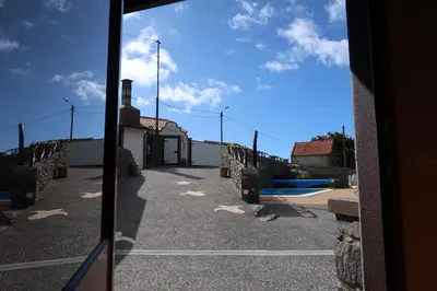 a mirror reflection of a building with a swimming pool at Vila Maria Quinta 6 
