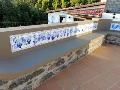 a balcony with blue and white porcelain railing at Vila Maria Quinta 6 