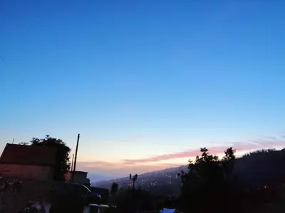 a view of the sun setting over a city at Vila Maria Quinta 6 