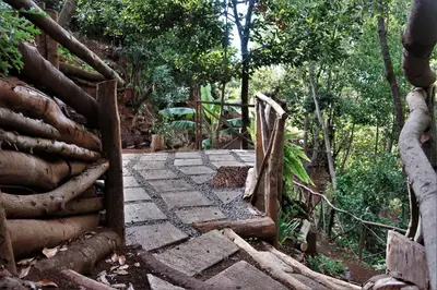 a wooden gate leading to a path in a forest at Vila Maria Quinta 2 