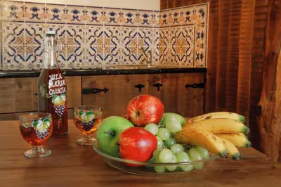 a bowl of fruit on a table with a bottle of soda at Vila Maria Quinta 1 