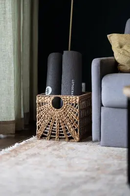 a wicker basket withaments on the floor next to a couch at maresoul - Ferienapartment soul in Raposeira