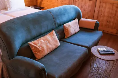 a couch with pillows on it in a room at Madeira Sunset Cottage - Nature Retreat in Ponta do Pargo