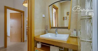 a bathroom with a sink and a mirror at Burgau Charming House Villa in Burgau