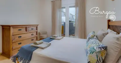 a bedroom with a bed with two towels on it at Burgau Charming House Villa in Burgau