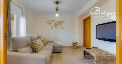 a living room with a couch and a flat screen tv at Burgau Charming House Villa in Burgau
