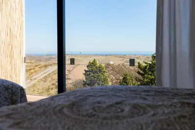 a bedroom with a large window with a view of the desert at Casa Kama in Raposeira