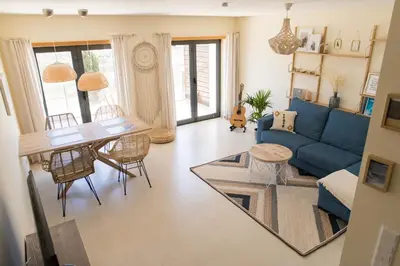 a living room with a blue couch and a table at Casa Kama in Raposeira