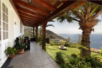 a porch of a house with a view of the ocean at O Meu Sonho in Calheta