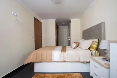a white bedroom with a bed and a desk at Antonella Home Funchal in Funchal
