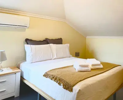 a bedroom with a bed with two towels on it at Antonella Home Funchal in Funchal