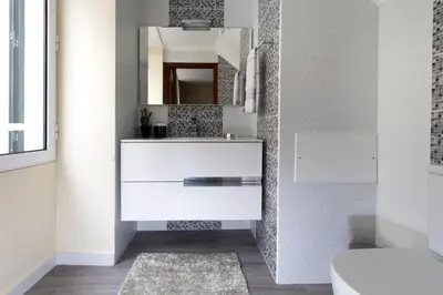 a bathroom with a white sink and a mirror at Antonella Home Funchal in Funchal