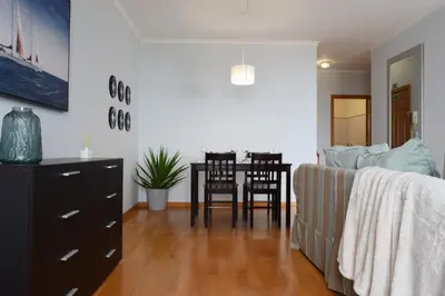a living room with a table and a couch at São Martinho, a Home in Madeira in Funchal