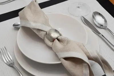 a white plate with a napkin on a table at São Martinho, a Home in Madeira in Funchal