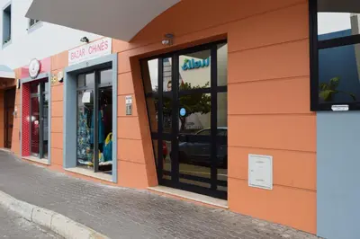 a row of shops on the side of a street at São Martinho, a Home in Madeira in Funchal