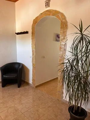 a black chair and a plant in a room at Casa d'Avó in Carrapateira