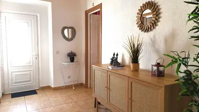 a hallway with a wooden dresser and a mirror at Casa d'Avó in Carrapateira