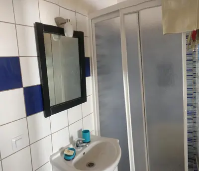a bathroom with a sink and a shower at Casa d'Avó in Carrapateira