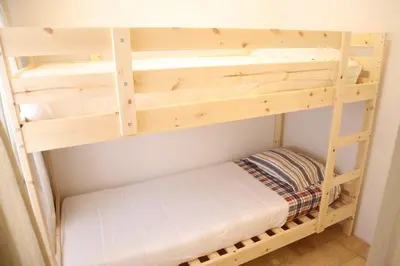 a wooden bunk bed in a room at Salema Beach Home in Salema