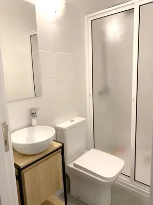 a bathroom with a toilet and a sink and a shower at Charming House in Funchal with Sea View in Funchal