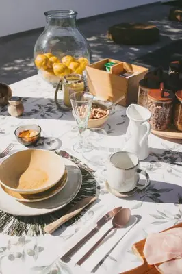 a table with plates and utensils on a white table cloth at Casa LNNoa Boutique Room whit private pool in Lagos