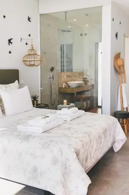 a bedroom with a large bed with towels on it at Casa LNNoa Boutique Room whit private pool in Lagos