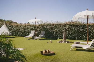 a yard with two lawn chairs and umbrellas at Casa LNNoa Boutique Room whit private pool in Lagos