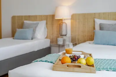 a tray of fruit on a table in a hotel room at Vila Papagaio Verde by An Island Apart in Funchal