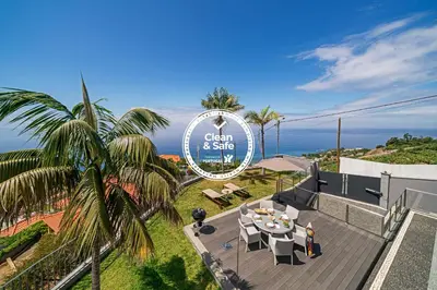 a view of the ocean from the balcony of a house at Vila Papagaio Verde by An Island Apart in Funchal