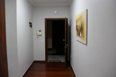 a hallway with a door and a painting on the wall at Doca do Cavacas Apartment in Funchal