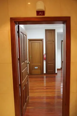 an open door into a hallway with two doors at Doca do Cavacas Apartment in Funchal