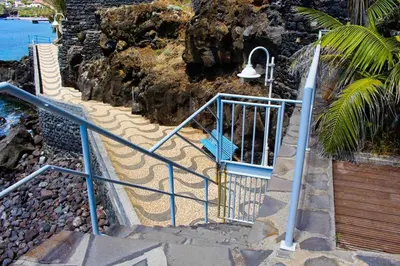 a set of stairs with a light and a bench at The Artist Villa in Santa Cruz