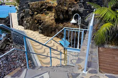 a set of stairs with a light and a bench at The Artist Villa in Santa Cruz