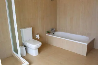 a bathroom with a white tub and a toilet at The Artist Villa in Santa Cruz