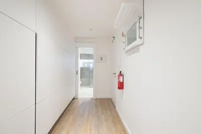 a hallway with white walls and a fire extinguisher at OLD TOWN Apartment W Interior Terrace - Barreirinha in Funchal