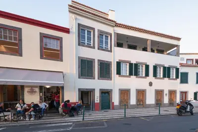 a group of people sitting outside of a building at OLD TOWN Apartment W Interior Terrace - Barreirinha in Funchal