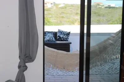 a hammock in a living room with a window at Beach Front Apartment 2 in Sagres